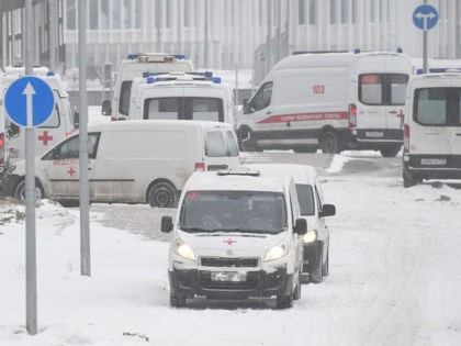 Ambulances are seen parked in the grounds of a hospital in Kommunarka, where patients suff