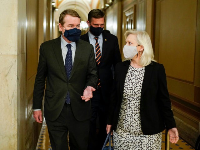 (From L) US Senators' Michael Bennet (D-CO), Martin Heinrich (D-NM) and Kirsten Gillibrand (D-NY) walk during dinner break in the second day of former US President Donald Trump's impeachment trial before the Senate on Capitol Hill February 10, 2021, in Washington, DC. - Democrats present the case against Donald Trump …