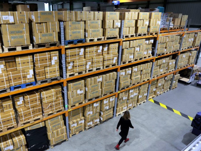 Employee Jessica Mueller walks alongside a medical stockpile at the vaccine warehouse where the Pfizer-Biontech Covid-19 corona virus vaccine will be preserved before their distribution on January 08, 2021 in Irxleben, near Magdeburg, eastern Germany. (Photo by Ronny Hartmann / AFP) (Photo by RONNY HARTMANN/AFP via Getty Images)