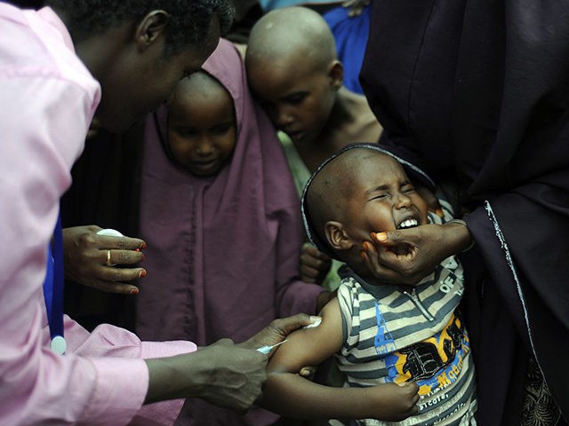 A young Somali refugee gets vaccinated at a paediatric vaccination centre at Hagadere refugee site within the Dadaab refugee complex in Kenya's north-east province on August 1, 2011. The children of Somali refugees who have arrived in Kenyan in great number recently are being vaccinated against polio and measles. An …