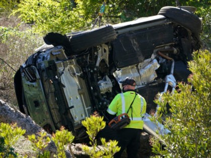 A vehicle rests on its side after a rollover accident involving golfer Tiger Woods Tuesday, Feb. 23, 2021, in Rancho Palos Verdes, Calif., a suburb of Los Angeles. Woods suffered leg injuries in the one-car accident and was undergoing surgery, authorities and his manager said. (AP Photo/Marcio Jose Sanchez)