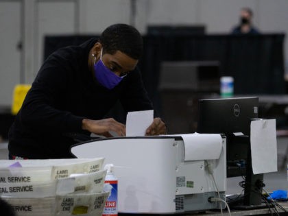 This January 6, 2020 file photo shows election officials counting votes for Fulton County for the Georgia Senate runoff. (Photo by Megan Varner/Getty Images)