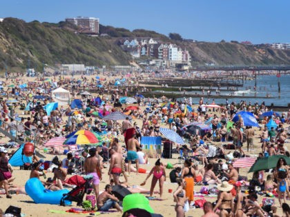 BOURNEMOUTH, ENGLAND - MAY 25: Tourists enjoy the hot weather at Bournemouth beach on May 25, 2020 in Bournemouth, United Kingdom. The British government has started easing the lockdown it imposed two months ago to curb the spread of Covid-19, abandoning its 'stay at home' slogan in favour of a …