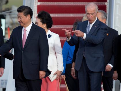 Vice President Joe Biden gestures toward Chinese President Xi Jinping and his wife Peng Liyuan during an arrival ceremony in Andrews Air Force Base, Md., Thursday, Sept. 24, 2015. Chinese President Xi Jinping and his wife Peng Liyuan are traveling to Washington for a State Visit. (AP Photo/Carolyn Kaster)