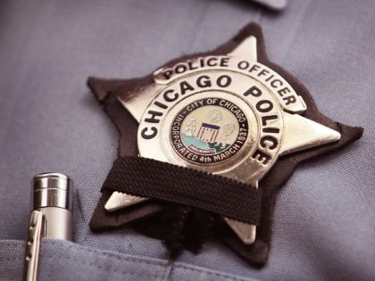 CHICAGO - JULY 19: A black band is stretched across a District 1 Chicago Police officer's badge to mourn the death of a fellow officer on July 19, 2010 in Chicago, Illinois. District 1 officer Michael Bailey was killed in front of his home after getting off duty Sunday morning …