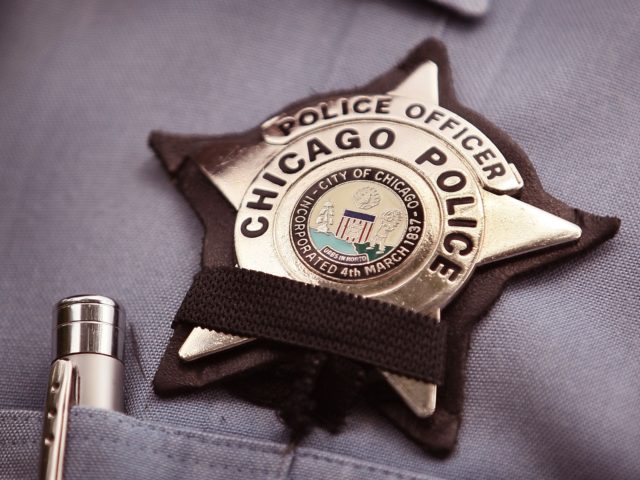 CHICAGO - JULY 19: A black band is stretched across a District 1 Chicago Police officer&#0