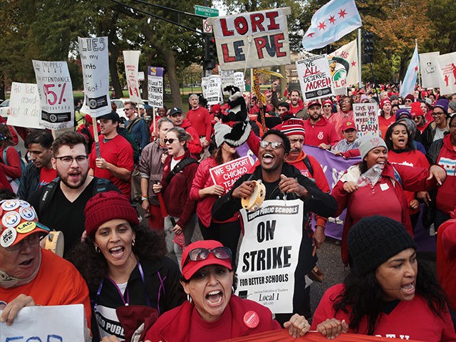CHICAGO, ILLINOIS - OCTOBER 21: Striking Chicago public school teachers and their supporters march through the city's west side on October 21, 2019 in Chicago, Illinois. About 25,000 Chicago school teachers went on strike last week after the Chicago Teachers Union (CTU) failed to reach a contract agreement with the …