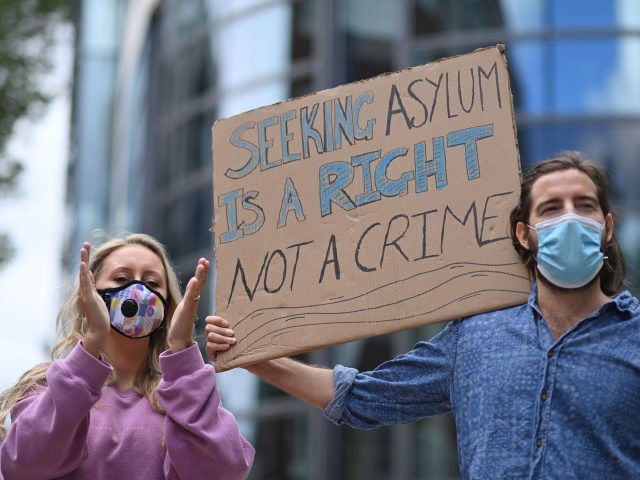 Protesters carry a placard at a demonstration to highlight conditions inside Brook House i