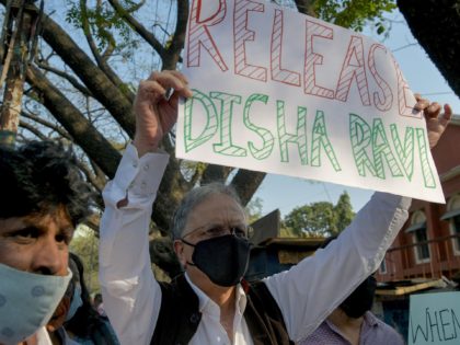 Historian, author and activist Ramachandra Guha (R) and various human rights organisation stage a demonstration against the arrest of the activist Disha Ravi by Delhi police for her alleged involvement with the violence during the farmers protest on India's Republic Day, in Bangalore on February 15, 2021. (Photo by Manjunath …