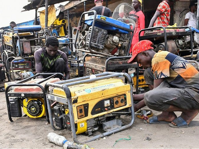 Young boys work on a generators at a workshop in the Bulabulin area of Maiduguri, on February 1, 2021. - Residents of northeast Nigerian city Maiduguri have been struggling with a power blackout for a week after jihadists blew up supply lines, causing water shortages and disrupting businesses and daily …
