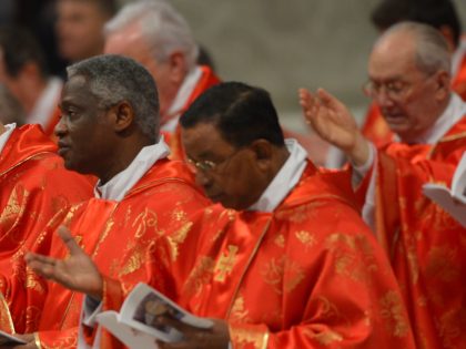Ghanaian cardinal Peter Kodwo Appiah Turkson (C) attend a mass at the St Peter's basilica before the conclave on March 12, 2013 at the Vatican. Cardinals moved into the Vatican today as the suspense mounted ahead of a secret papal election with no clear frontrunner to steer the Catholic world …