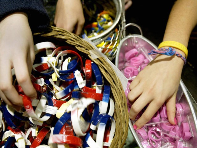 Children browse through multi-colored bracelets 22 December 2004 at a clothing store in th
