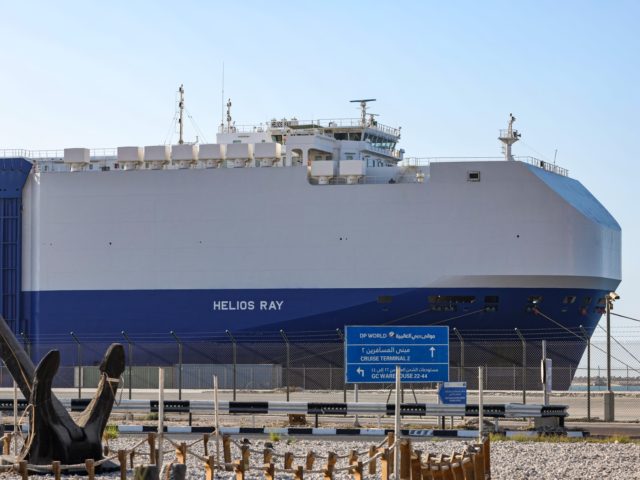 This picture taken on February 28, 2021 shows a view of the Israeli-owned Bahamian-flagged MV Helios Ray cargo ship docked in Dubai's Mina Rashid (Port Rashid) cruise terminal. - The MV Helios Ray, a vehicle carrier, was travelling from the Saudi port of Dammam to Singapore when a blast occurred …