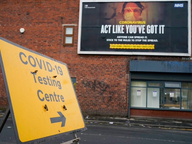 WALSALL, UNITED KINGDOM - FEBRUARY 04: A Covid-19 testing site direction sign and a government pandemic poster in the Leamore area of Walsall as mass testing is started to track down a South African coronavirus variant found in the area on February 04, 2021 in Walsall, United Kingdom. Health authorities …