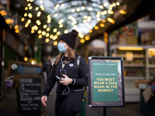 A sign informs people that it is mandatory to wear face masks at Borough Market in London