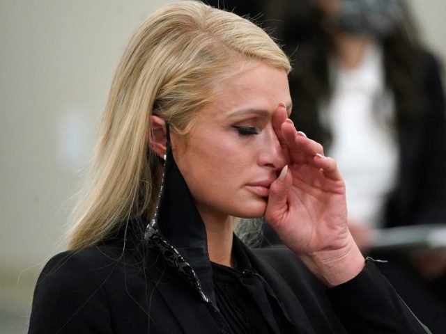 Paris Hilton wipes her eyes after speaking at a committee hearing at the Utah State Capito