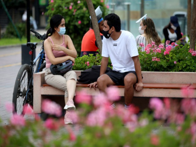 A couple wearing face masks talks on the bench in a park of Miraflores ahead of Lima's total lockdown to stop surge of coronavirus cases on January 30, 2021 in Lima, Peru. President Francisco Sagasti ordered total lockdown in Lima and nine other regions from January 31 to February 14 …