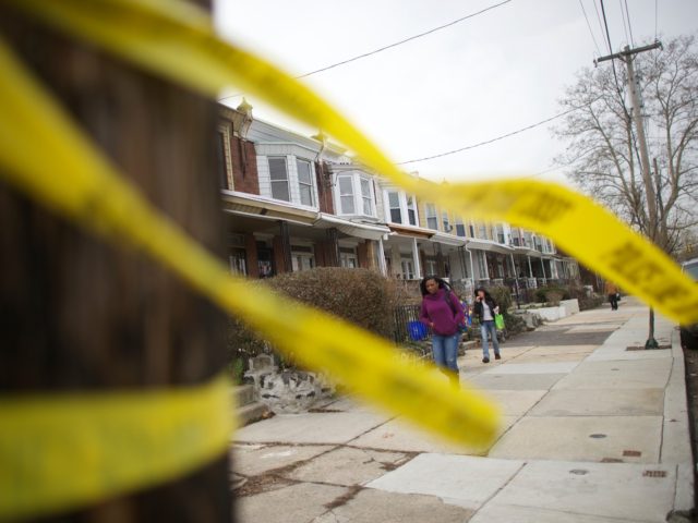 PHILADELPHIA, PA - JANUARY 8: Women walk past police tape near the scene of a shooting ambush last night of 33-year-old Police Officer Jesse Hartnett, who was shot 13 times at close range on January 8, 2016 in Philadelphia, Pennsylvania. Surveillance footage reveals a suspect dressed in Muslim clothing and …