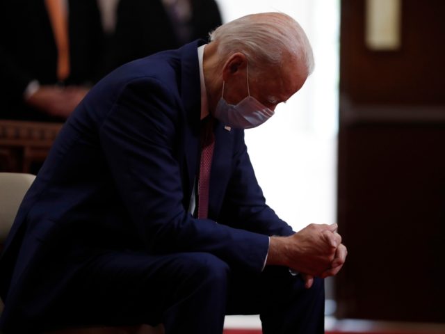 FILE - In this June 1, 2020, file photo, Democratic presidential candidate, former Vice President Joe Biden bows his head in prayer as he visits Bethel AME Church in Wilmington, Del. Photos in a campaign ad for President Donald Trump show that former Vice President Biden is “alone, hiding, diminished.” …