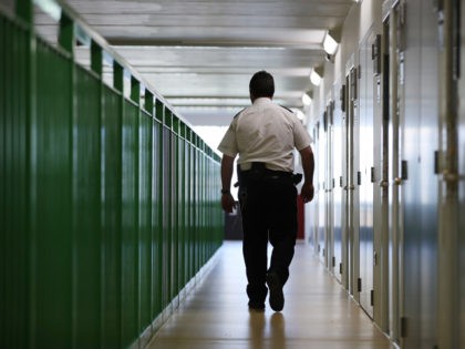 WREXHAM, WALES - MARCH 15: A prison guard walks through a cell area at HMP Berwyn on March