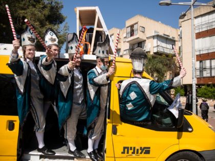 BENE BERAQ, ISRAEL - FEBRUARY 26: Ultra Orthodox Jews wearing costumes to celebrate the holiday of Purim on February 26, 2021 in Bene Beraq, Israel. The government imposed a nightly curfew from Thursday through Sunday morning in an attempt to prevent public gatherings for the holiday, out of concern they …