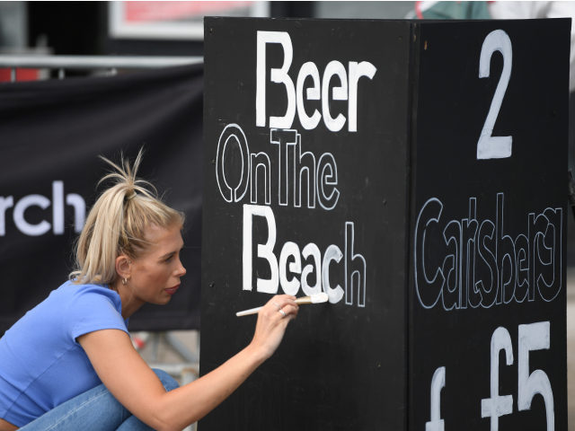 BRIGHTON, ENGLAND - MAY 16: A seafront nightclub opens to sell beer on Brighton beach on M