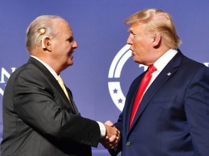 Rush Limbaugh shakes hands with US President Donald Trump during the Turning Point USA Student Action Summit at the Palm Beach County Convention Center in West Palm Beach, Florida on December 21, 2019. (Photo by Nicholas Kamm / AFP) (Photo by NICHOLAS KAMM/AFP via Getty Images)