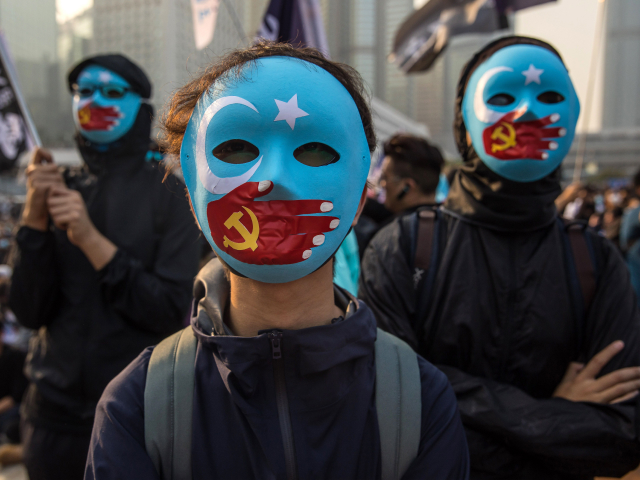 TOPSHOT - Protesters attend a rally in Hong Kong on December 22, 2019 to show support for the Uighur minority in China. - ong Kong riot police broke up a rally in solidarity with China's Uighurs on December 22 as the city's pro-democracy movement likened their plight to that of the oppressed Muslim minority. (Photo by Dale DE LA REY / AFP) (Photo by DALE DE LA REY/AFP via Getty Images)
