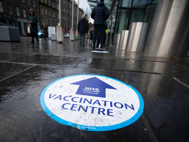 EDINBURGH, SCOTLAND - FEBRUARY 01: A sign on the floor in the waiting area outside the main entrance to the coronavirus mass vaccine centre on February 1, 2021 in Edinburgh, Scotland. Mass vaccination centres, including Edinburgh International Conference Centre and Aberdeen’s P&J LIVE at TECA, opened today as the vaccination …