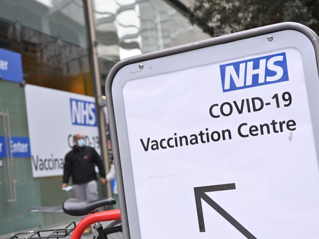 A pedestrian walks past an NHS Covid-19 vaccination centre in Westfield Stratford City shopping centre in east London on February 6, 2021 as Britain's largest ever vaccination programme continues. - More than 10 million people have received a first dose of a Covid-19 vaccine in Britain, according to government statistics …