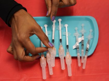 In this Jan. 22, 2021, file photo, Tina Killebrew, a certified medical assistant, prepares doses of the Pfizer-BioNTech COVID-19 vaccine at a vaccination center at the University of Nevada, Las Vegas in Las Vegas. A racial gap has opened up in the nation's COVID-19 vaccination drive, with Black Americans in …