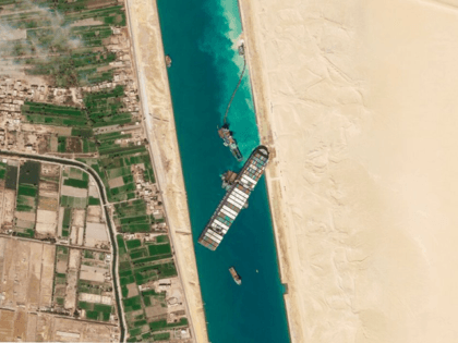 In this March 28, 2021, satellite file image from Planet Labs Inc, the cargo ship MV Ever Given sits stuck in the Suez Canal near Suez, Egypt. Consumers may face shortages and higher prices for electronics, toys, furniture and other goods should attempts to free the mammoth container ship stuck …