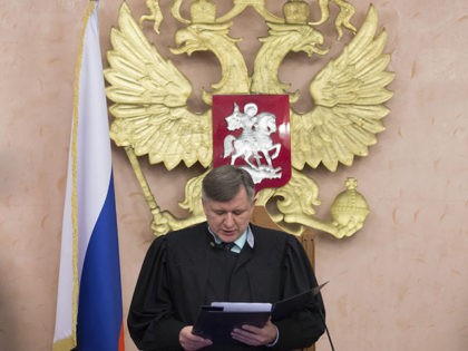Russia's Supreme Court judge Yuri Ivanenko reads the decision in a court room in Moscow, R