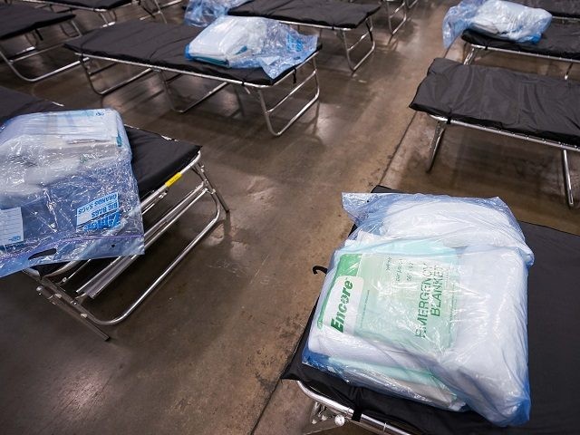 Cots are staged for setup as Texas Army National Guardsmen set up a field hospital in response to the new coronavirus crisis at the Kay Bailey Hutchison Convention Center on Tuesday, March 31, 2020, in Dallas. Dallas County has the most COVID-19 cases of any county in Texas, a key …