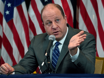 Colorado Governor Jared Polis makes a point during a news conference at the Governor's Man