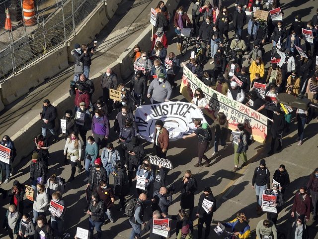 Hundreds of demonstrators march through Minneapolis following protests near the Hennepin County Government Center, Monday, March 8, 2021, in Minneapolis where the trial for former Minneapolis police officer Derek Chauvin began with jury selection. Chauvin is charged with murder in the death of George Floyd during an arrest last May …