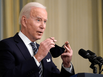 President Joe Biden puts his face mask on after speaking about the COVID-19 relief package in the State Dining Room of the White House, Monday, March 15, 2021, in Washington. (AP Photo/Patrick Semansky)