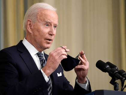 President Joe Biden puts his face mask on after speaking about the COVID-19 relief package