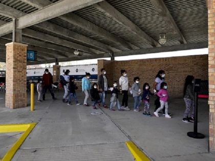 Migrants stand in line after being released from U.S. Customs and Border Protection custody at a bus station, Wednesday, March 17, 2021, in Brownsville, Texas. Team Brownsville, a humanitarian group, is helping the migrants reach their final destination in the U.S. A surge of migrants on the Southwest border has …