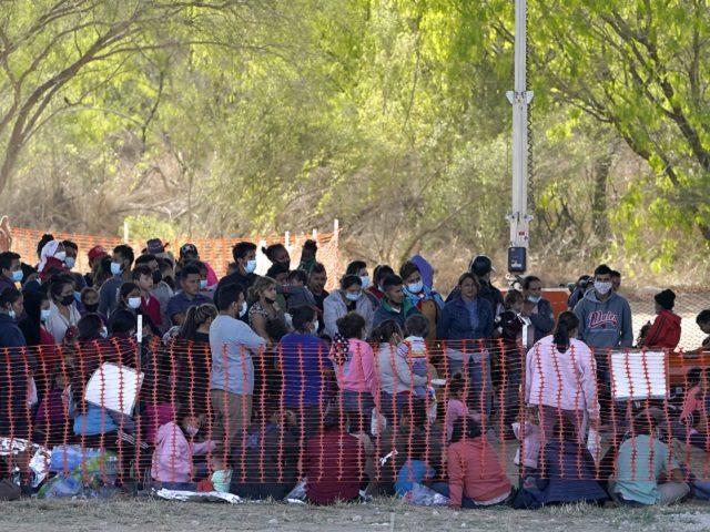 Migrants are seen in custody at a U.S. Customs and Border Protection processing area under the Anzalduas International Bridge, Friday, March 19, 2021, in Mission, Texas. A surge of migrants on the Southwest border has the Biden administration on the defensive. The head of Homeland Security acknowledged the severity of …
