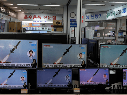 A man wearing a face mask stands near TV screens showing a news program reporting about North Korea's missiles with file images at an electronic shop in Seoul, South Korea, Wednesday, March 24, 2021. North Korea fired short-range missiles this past weekend, just days after the sister of Kim Jong …