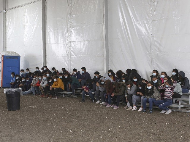 Newly migrants wait to enter the intake area at the Donna Processing Center, run by the U.S. Customs and Border Patrol (CBP), the main detention center for unaccompanied children in the Rio Grande Valley, in Donna, Texas, Tuesday, March 30, 2021. (AP Photo/Dario Lopez-Mills, Pool)