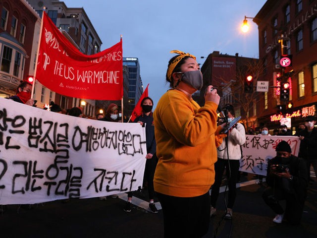 WASHINGTON, DC - MARCH 17: Activists participate in a vigil in response to the Atlanta spa shootings March 17, 2021 in the Chinatown area of Washington, DC. A gunman opened fire in three spas in the Atlanta, Georgia area, the day before killing eight people, including six women of Asian …