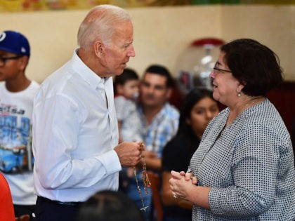 Democratic party candidate Joe Biden is given a rosary while meeting with patrons, alongside Hilda Solis (L), Former United States Secretary of Labor and a member of the Los Angeles County Board of Supervisors, of Tamales Lilianas restaurant in Los Angeles, California on July 19, 2019. - Democrats are gearing …