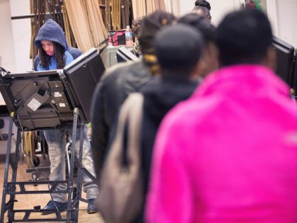 FERGUSON, MO - NOVEMBER 04: Treveyon Brock casts his ballot as people wait in line at poll