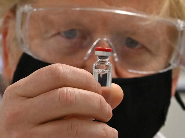 WREXHAM, WALES - NOVEMBER 30: UK Prime Minister Boris Johnson poses for a photograph with a vial of the AstraZeneca/Oxford University COVID-19 candidate vaccine, known as AZD1222, at Wockhardt's pharmaceutical manufacturing facility on November 30, 2020 in Wrexham, Wales. The UK government announced a deal in August with global pharmaceutical …