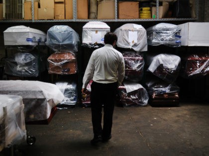 In this file photo, James Harvey tends tends to the inventory of pre-sold caskets at a funeral home on April 29, 2020 in New York City. (Spencer Platt/Getty Images)