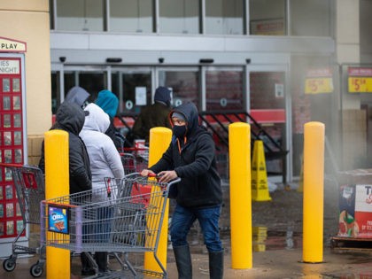 AUSTIN, TX - FEBRUARY 17, 2021: People wait in long lines at an H-E-B grocery store in Aus