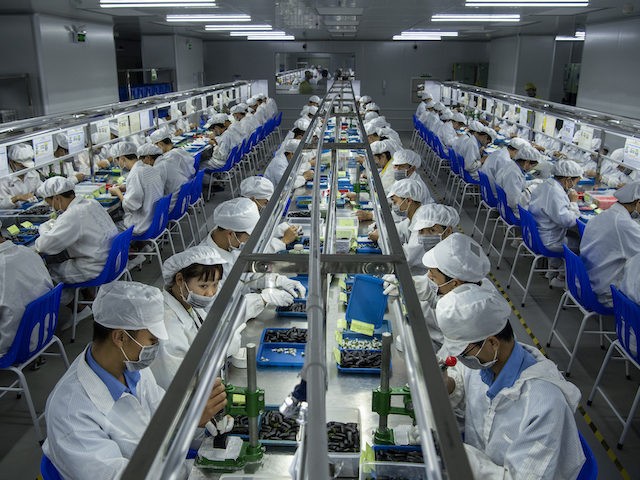 Workers make pods for e-cigarettes on the production line at Kanger Tech, one of China's l