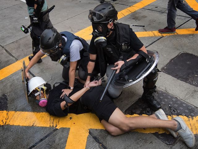 Police arrest a protester in the Wanchai area of Hong Kong on October 1, 2019, as the city
